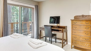 A bedroom with a bed, a desk, a chair, a dresser, and a television. - Forest-view Haven w/ Game Room: Tahoe City Gem! (Tahoe City)