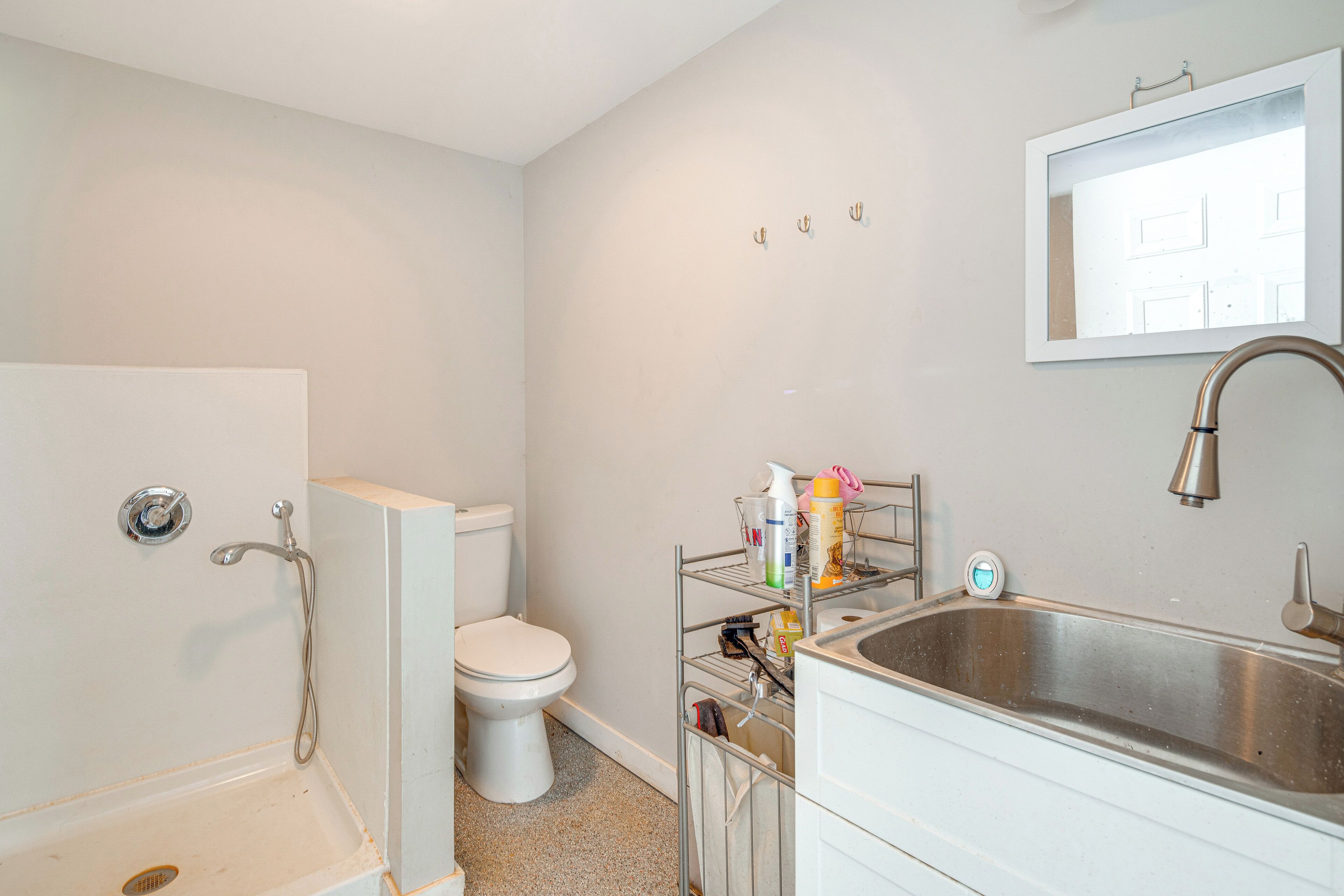 A bathroom with a bathtub, toilet, sink, and a mirror.