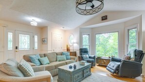 A spacious living room with a sectional sofa, a recliner, and a coffee table. - Blue Ridge Mtn Retreat: Porches & Creek Access (Hendersonville)