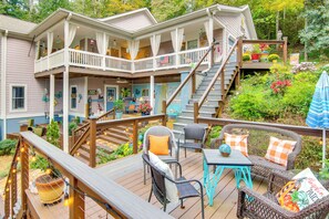 A two-story house with a deck, outdoor seating, and a staircase. - Blue Ridge Mtn Retreat: Porches & Creek Access (Hendersonville)