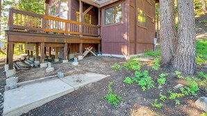 A wooden cabin with a balcony, surrounded by trees and a dirt ground. - Deck w/ Mountain Views: Cabin in Bear Valley! (Arnold)
