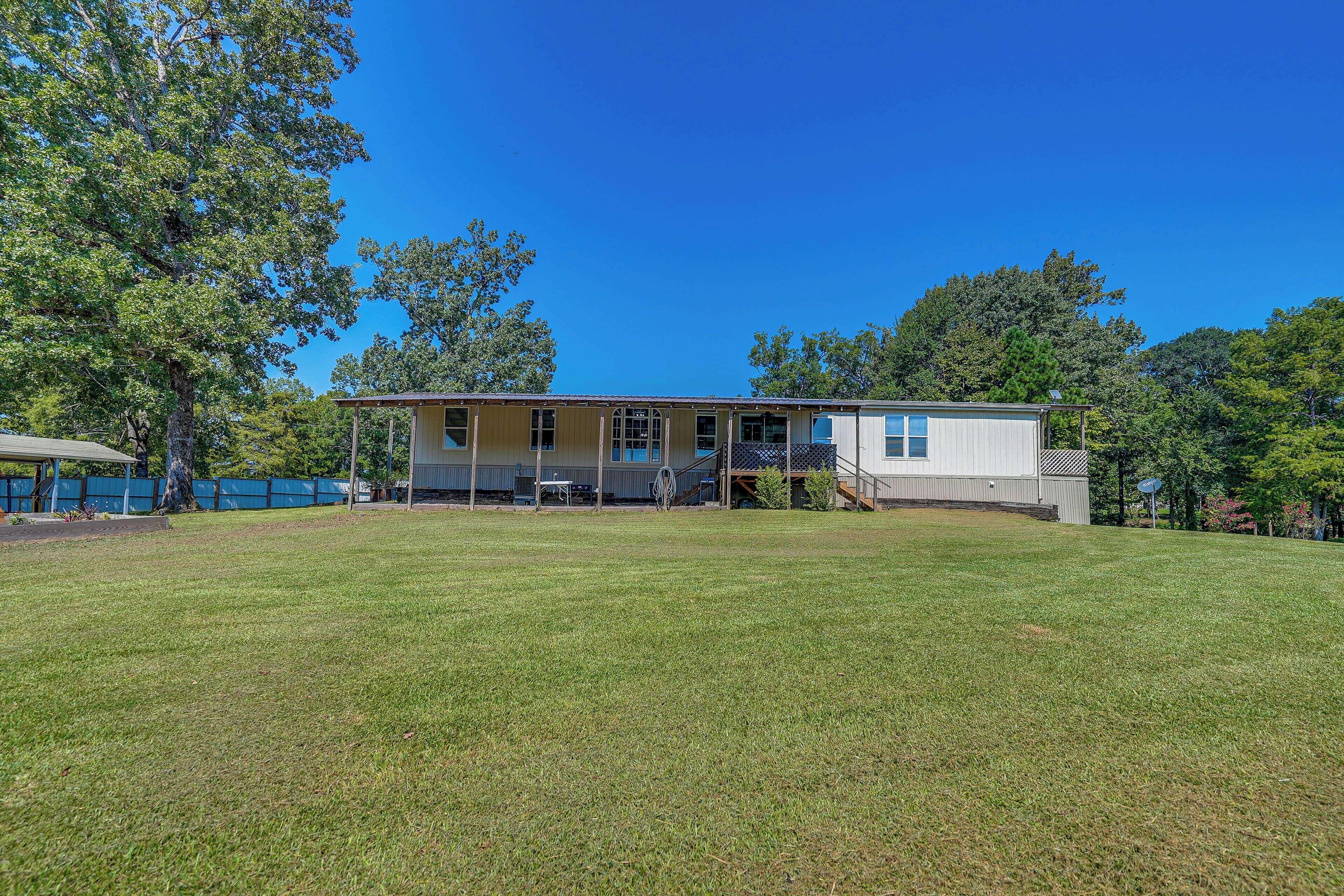 A single-story house with a covered porch and a fenced yard.