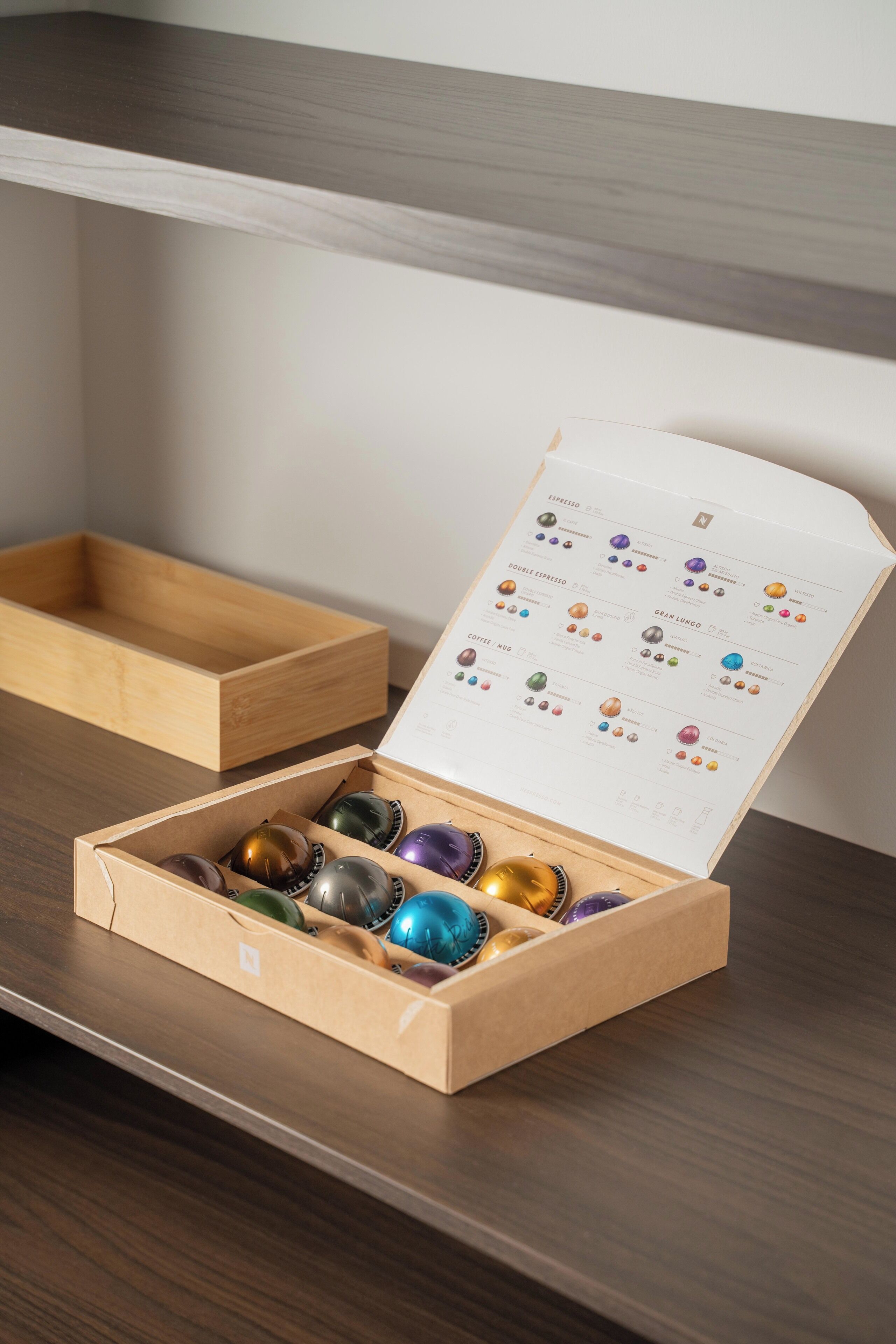 A wooden box with a booklet and colorful coffee beans.