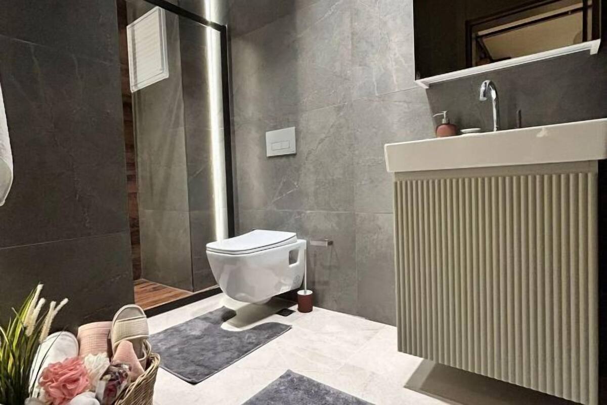 Shower, hair dryer, slippers, towels