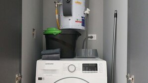 A compact laundry room with a Samsung washer and a water heater. - w Resplendent 2BR w Great Balcony in San Isidro (Lima)