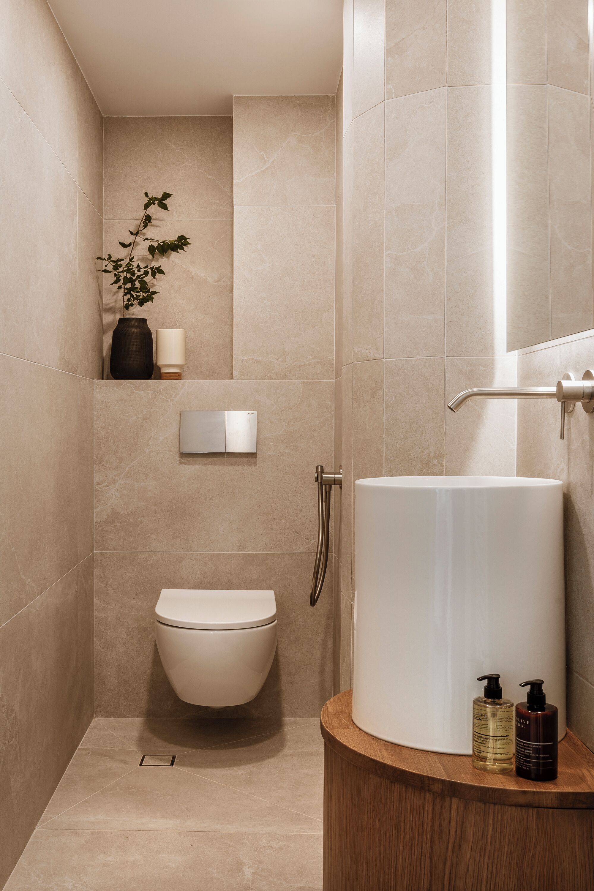 A modern bathroom with a toilet, sink, and shower.