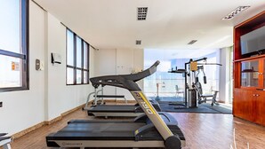 A gym with treadmills, a stationary bike, and a weight machine.