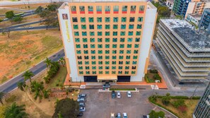 A high-rise hotel with a uniform facade, multiple floors, and a central entrance. - Apartamento no hotel Comfort (Taguatinga)