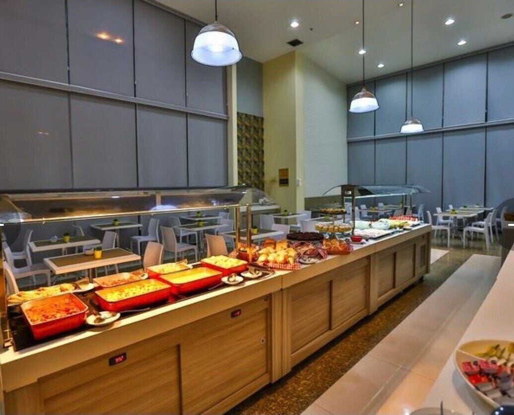 A buffet area with various food items and a seating arrangement with tables and chairs.