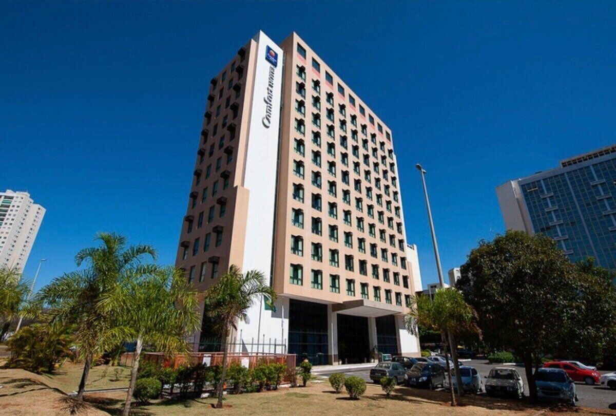 A tall, multi-story hotel with a prominent sign on the side.