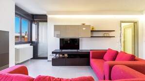 A modern living room with a flat-screen TV, a red sofa, and a minimalist design. - 4021 Casa Dolce Margherita by Barbarhouse (Casarano)