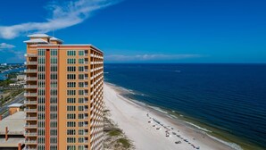 A high-rise hotel with multiple balconies overlooking a beach. - Phoenix Orange Beach 804 3 Bedroom Condo (Orange Beach)