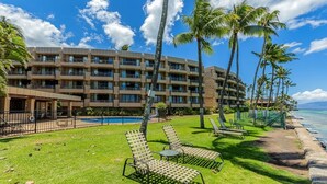 A hotel with multiple balconies, a swimming pool, and a beach view. - Paki Maui 411 1 Bedroom Condo (Lahaina)