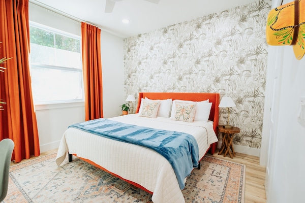 Bedroom Oasis: Relax in style with vibrant decor and serene nature views!