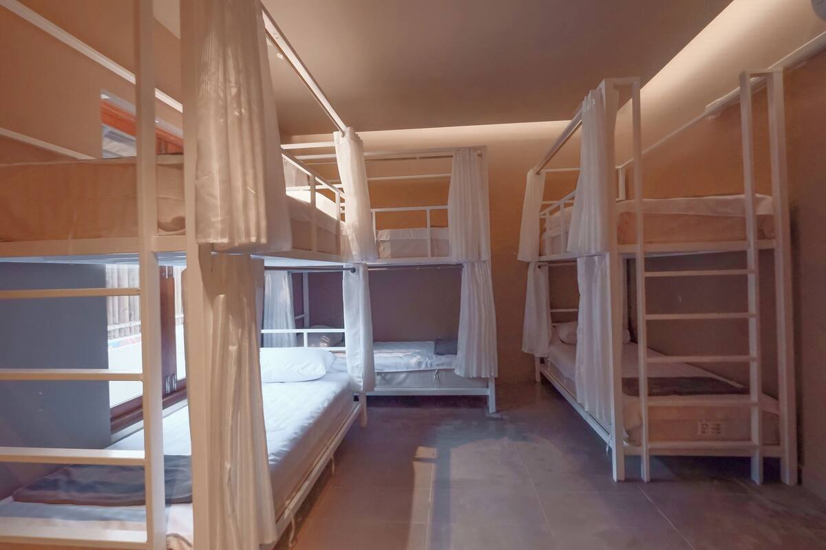 A room with bunk beds and storage shelves.
