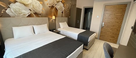Triple Room, Private Bathroom, City View | In-room safe, desk, laptop workspace, soundproofing