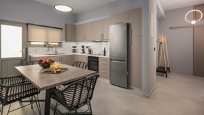 A modern kitchen with a dining area, stainless steel appliances, and a minimalist design. - Casa Amarillo is the perfect place for your holidays (Chania)