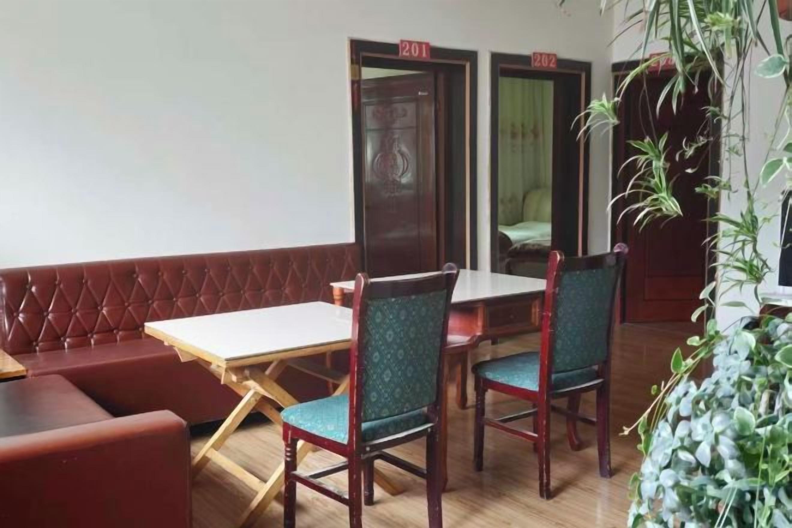 A dining area with a booth seating arrangement, a table, and chairs.