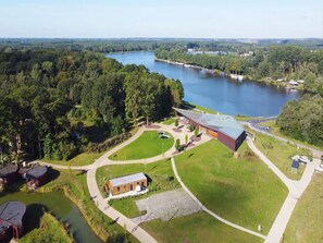 A lakeside property with a large building, a smaller structure, and a boat dock. - Bayleaf: Nature's Escape (Antoing)