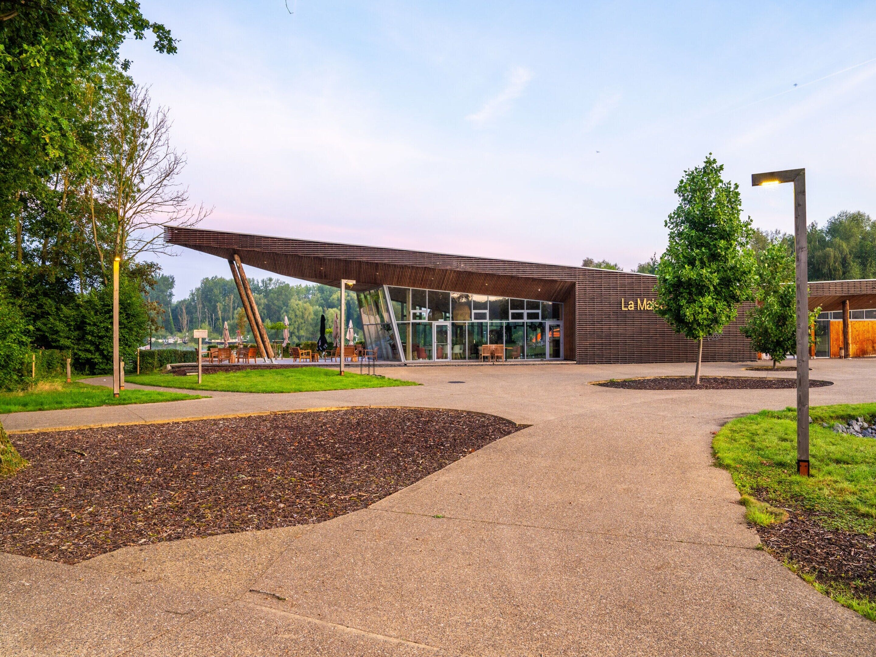 A modern building with a glass facade and a wooden exterior.