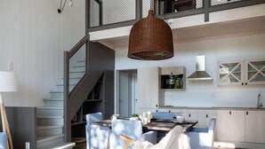 A modern kitchen with a dining area, a staircase, and a large window. - Getaway With Pool Access (Antoing)