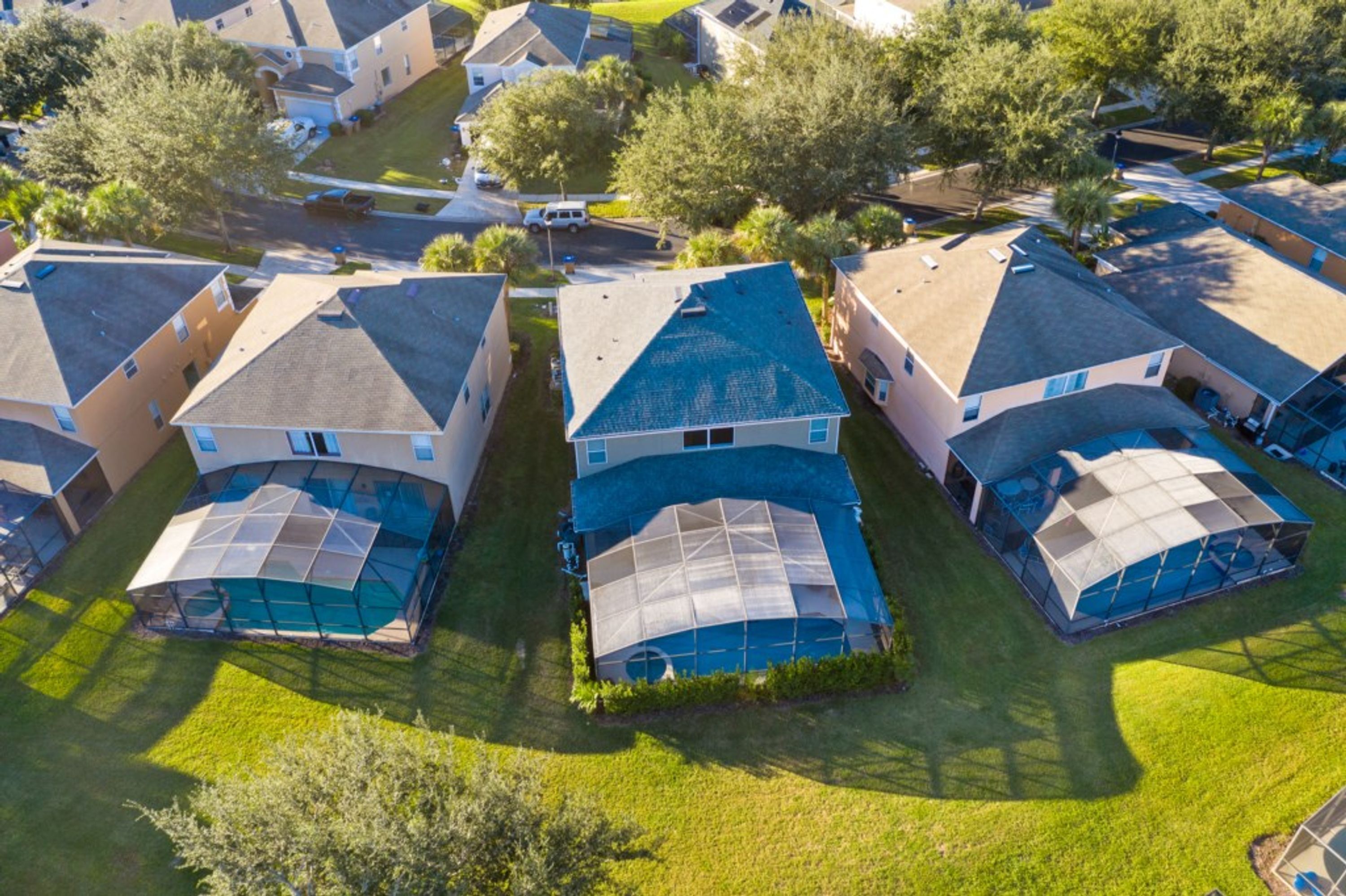 A residential area with houses featuring sloped roofs and large, covered outdoor spaces.