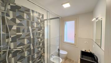 Een douche, een haardroger, een bidet, handdoeken