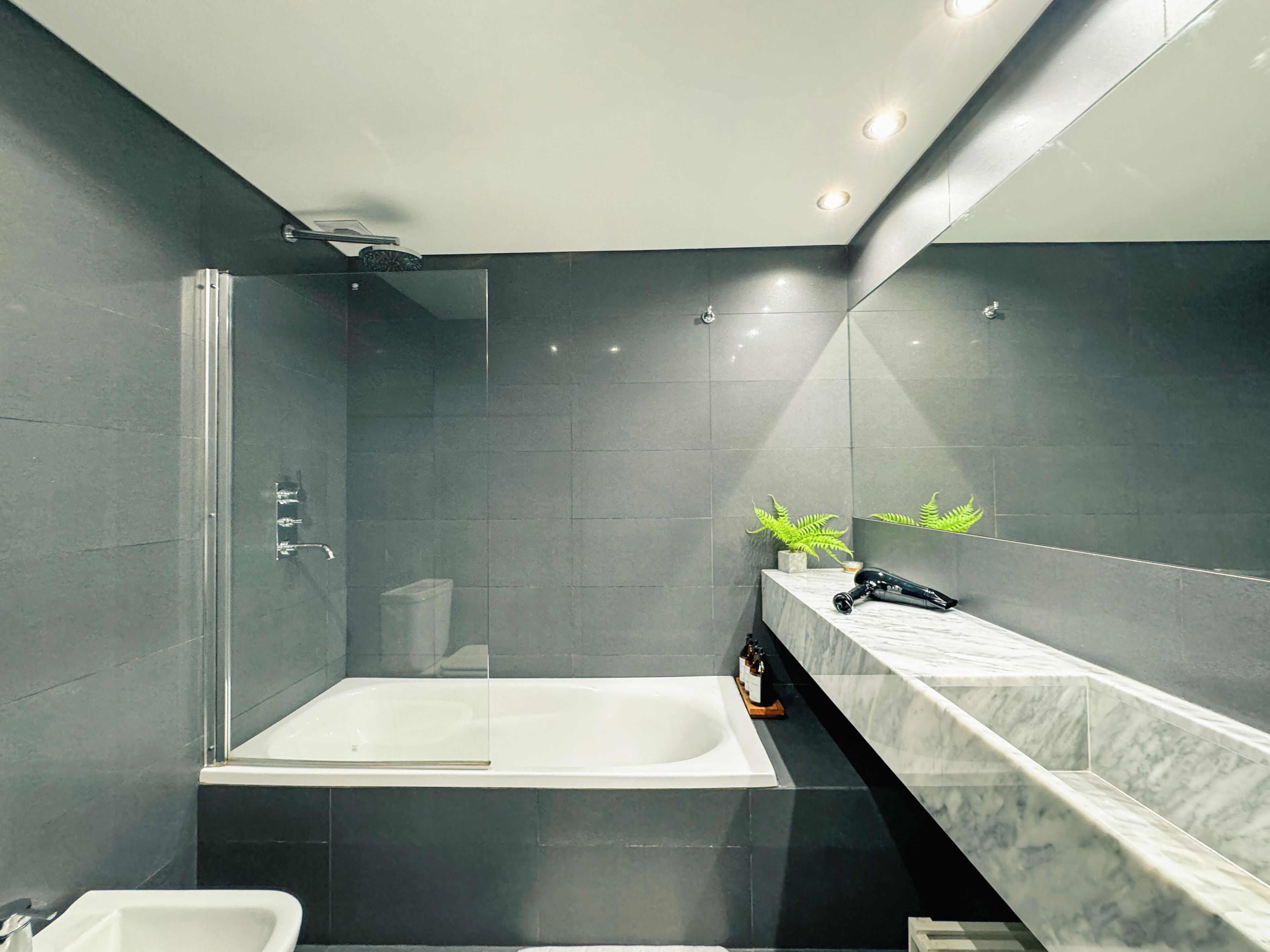 Deluxe Studio, Balcony, City View | Bathroom | Combined shower/tub, rainfall showerhead, eco-friendly toiletries