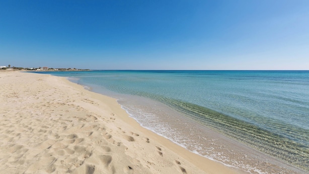 A wide sandy beach with clear blue water and a few footprints. - 4033 Villetta Stefy by Barbarhouse (Porto Cesareo)