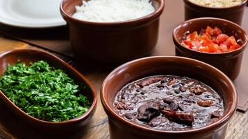 A table with various dishes including rice, beans, and a salad.