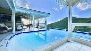 A pool area with a view of a mountain. - Private 3bdr ocean view villa (Cole Bay)