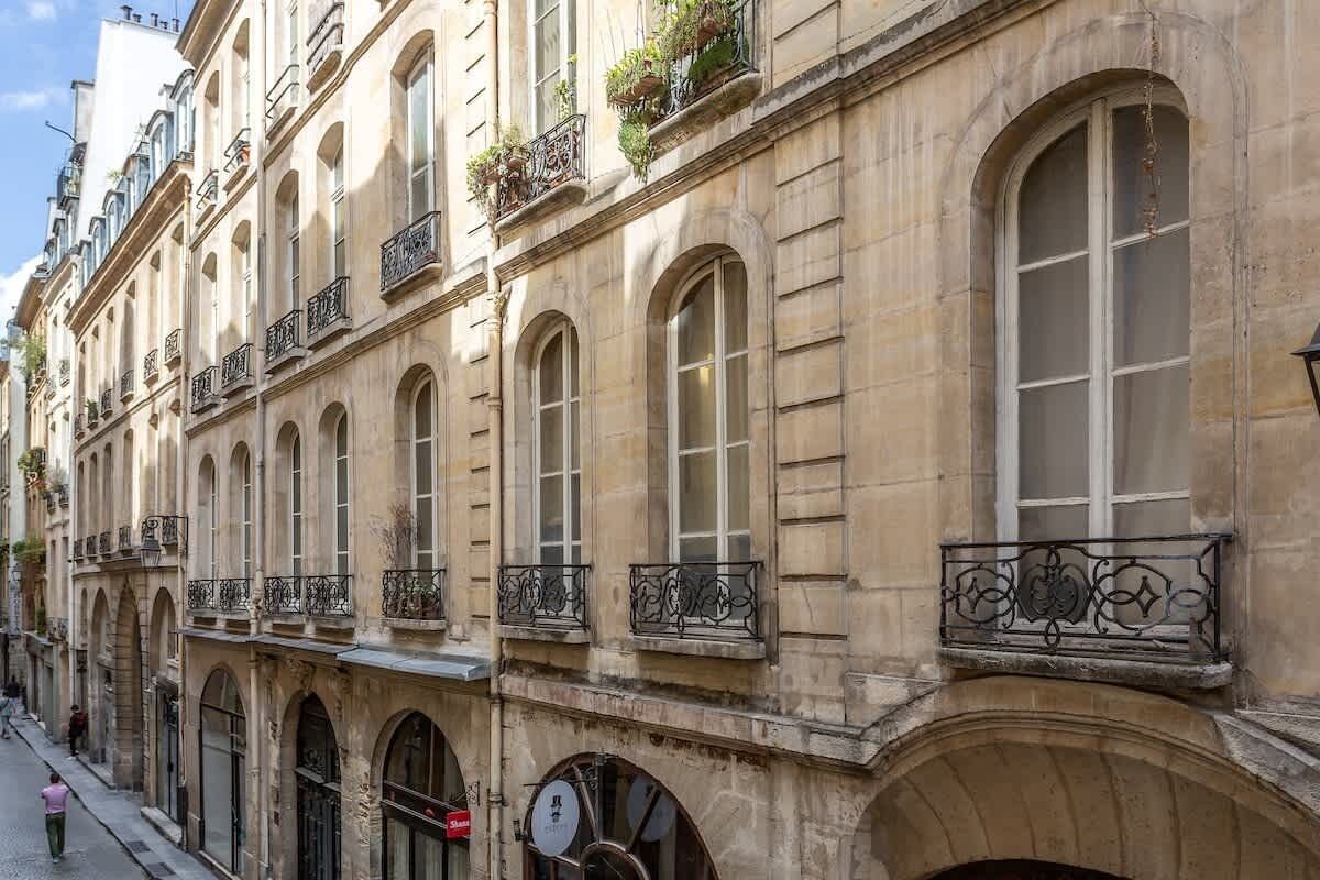 A historic building with arched windows and balconies with wrought iron railings.