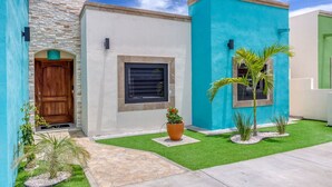 A modern house with a stone facade, a wooden door, and a blue exterior. - Walkable Convenient in Downtown Los Barriles (Los Barriles)