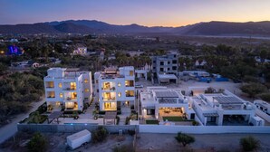 A modern residential complex with multiple buildings, each featuring balconies and outdoor seating areas. - Pool Condo, just a few steps from the beach -north (Los Barriles)