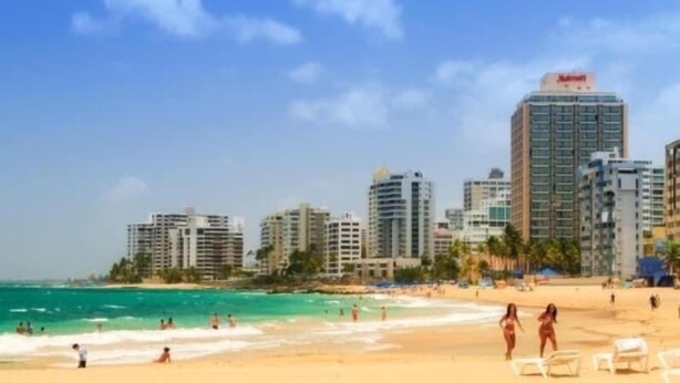A beach with a city skyline in the background, including a Marriott hotel. - Water tank 5 Min Airport & Beach Jacuzzi, BBQ-Kids Pool,Ping Pong -Solar Panels (Carolina)