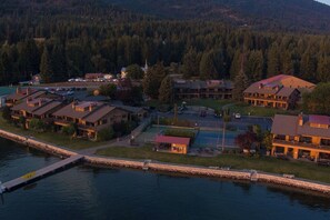 A lakeside resort with multiple buildings, a dock, and a small boat. - 1 Bedroom with Mountain View (Hope)