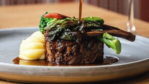 A dish with a sauce being poured over it.