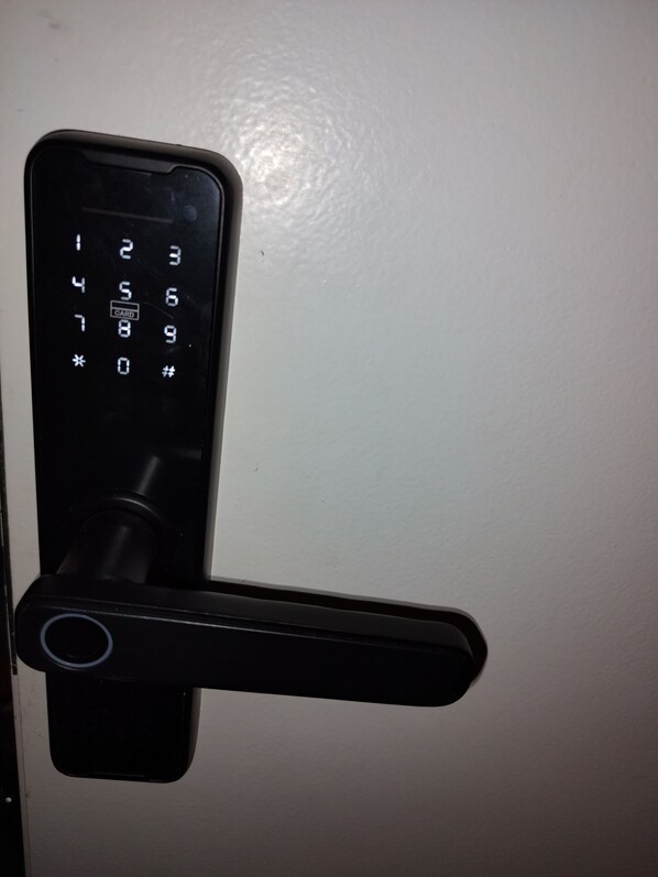 A door with a numeric keypad and a lever handle.