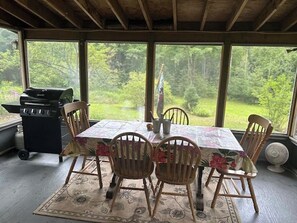 Enjoy al fresco dining in this outdoor space with a grill and comfortable seating for four.