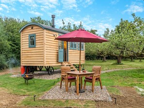 Outdoor dining - Set among the fruit trees with views of the fields. (Ongar)