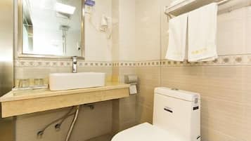 A bathroom with a sink, mirror, towel rack, and toilet.