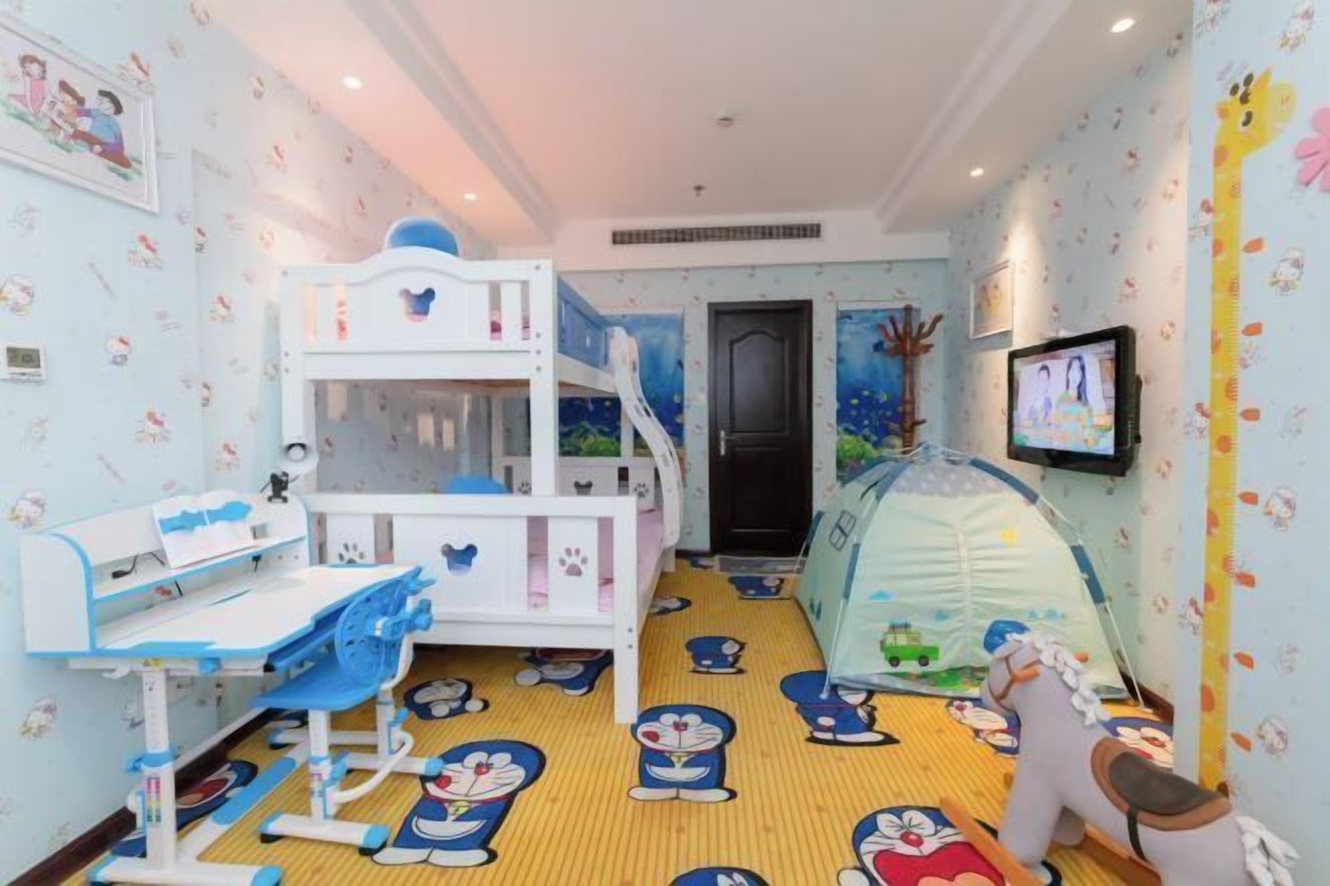 A children's playroom with a bunk bed, play desk, and a tent.