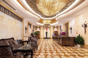 A lobby with a patterned floor, a chandelier, and a reception desk. - Jundu Boutique Hotel (Jinhua Stadium) (Jinhua)