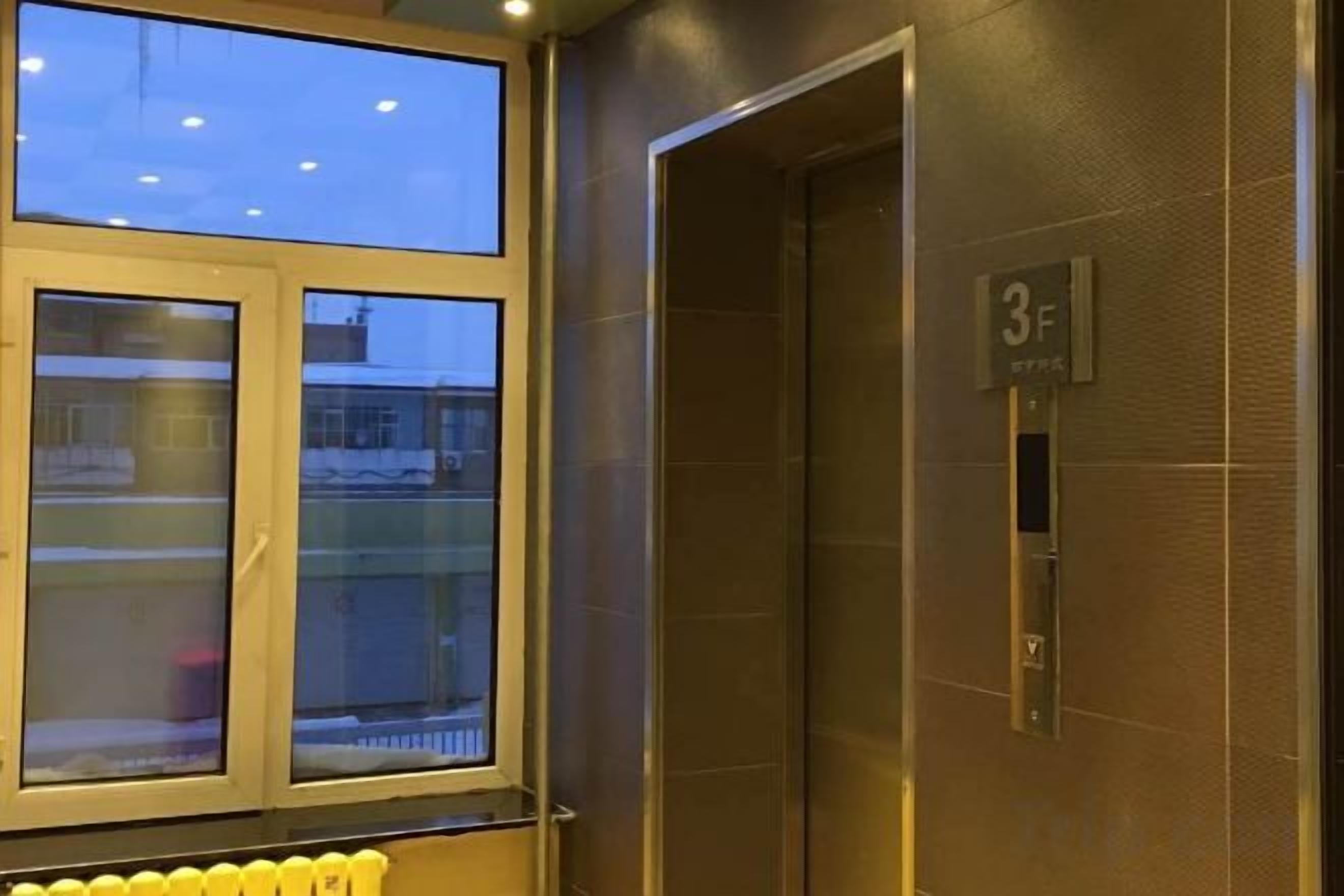 An elevator with a metallic finish and a visible floor indicator marked '3F'.