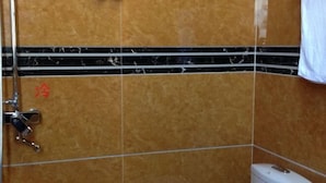 A bathroom with a shower, a toilet, and a towel rack. - Citadel Luoping (Luoping)