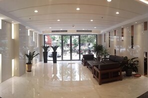 A spacious lobby with a polished floor, seating area, and large windows. - Weistin Hotel (Taishan)