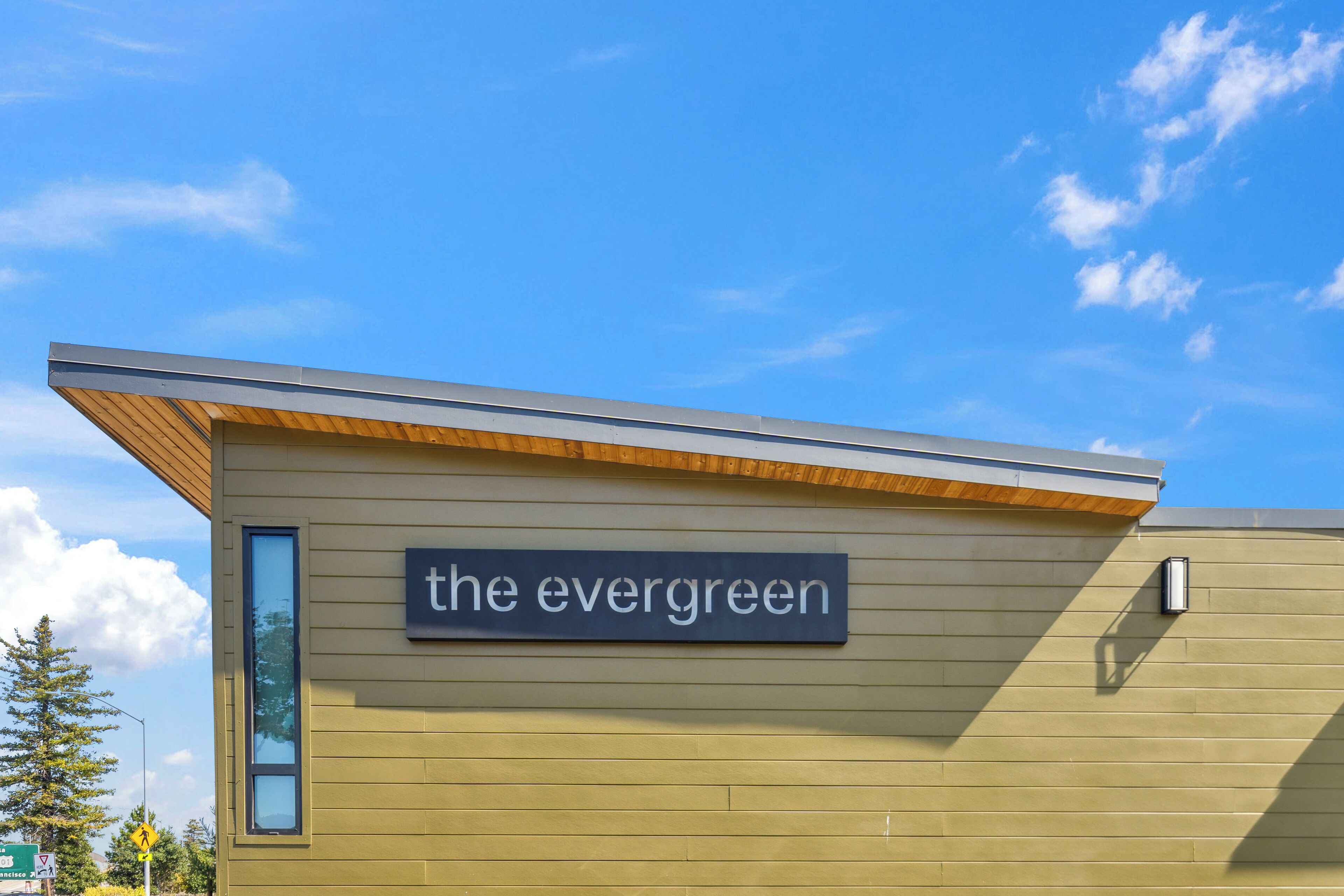 A building with a sign reading "the evergreen."