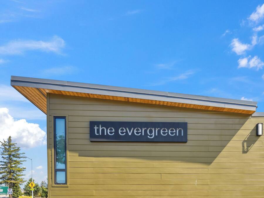 A building with a sign reading "the evergreen."