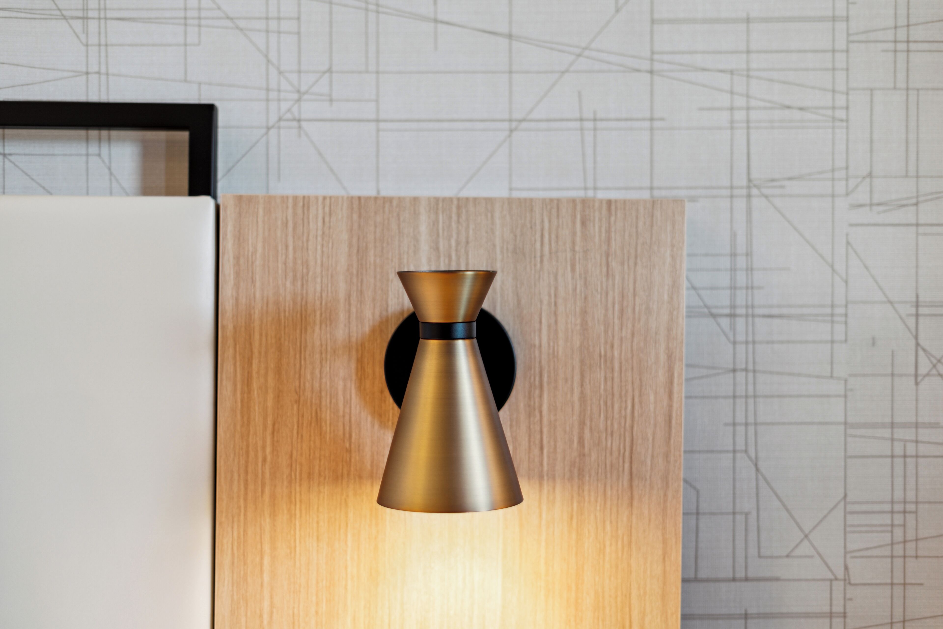 A modern kitchen with a wooden cabinet and a metallic pendant light fixture.