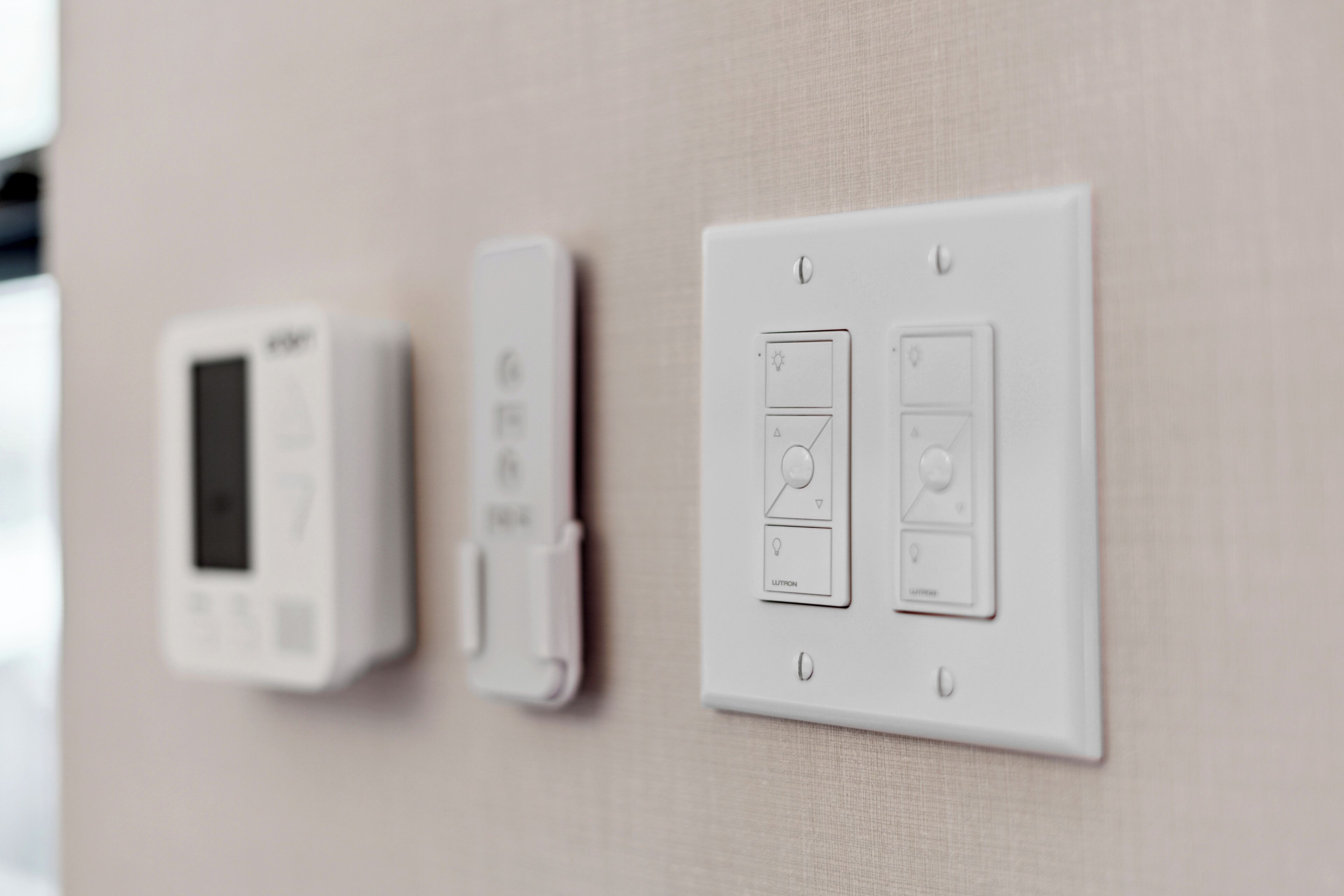 A wall-mounted thermostat and control panel with multiple settings.